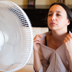 Woman attempys to stay cool in her home