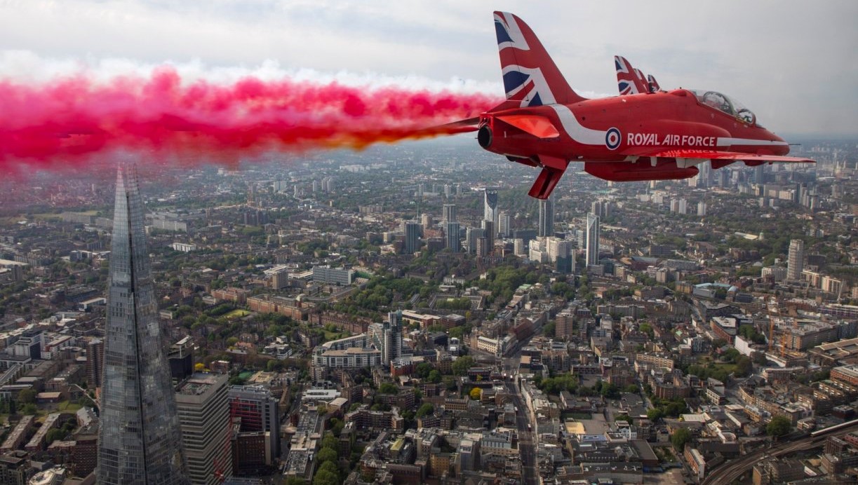 Red Arrow flying above a city