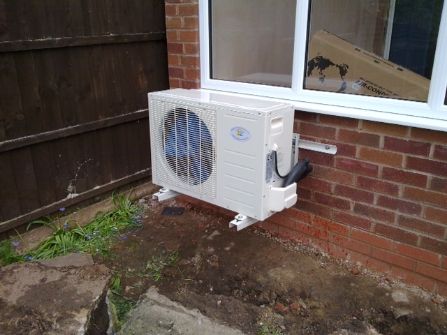 Air source heat pump outside a house