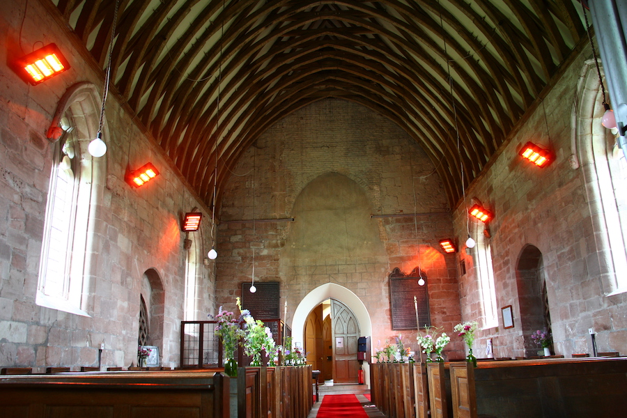 Inside of a church showing the aisle and pews