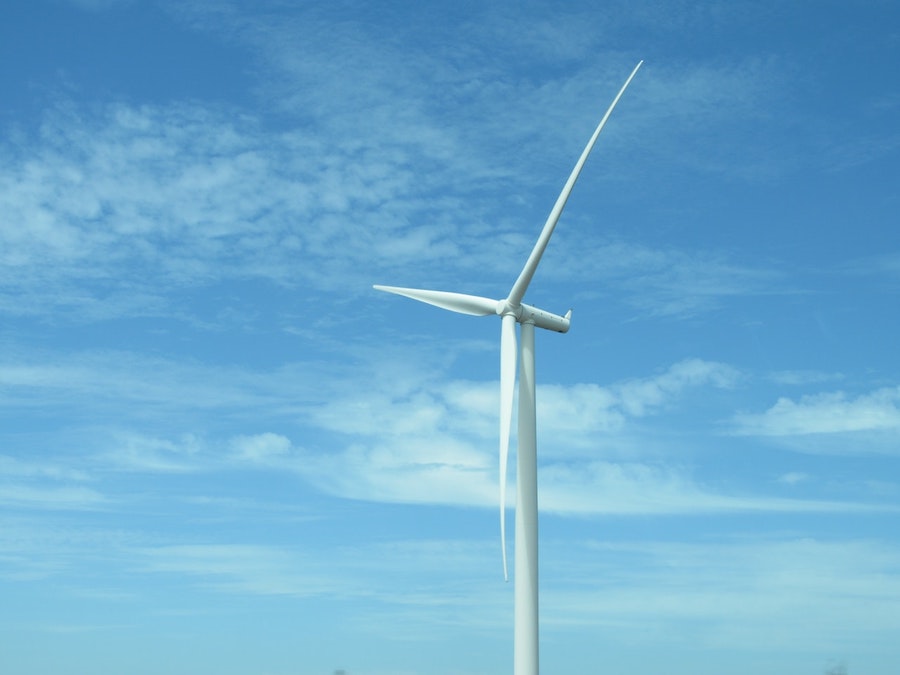 A wind turbine in a blue sky