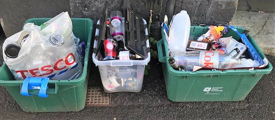 Curbside recycling boxes with plastic recycling waste.