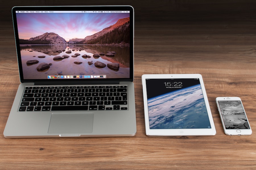 A MacBook Air next to an iPad and Iphone